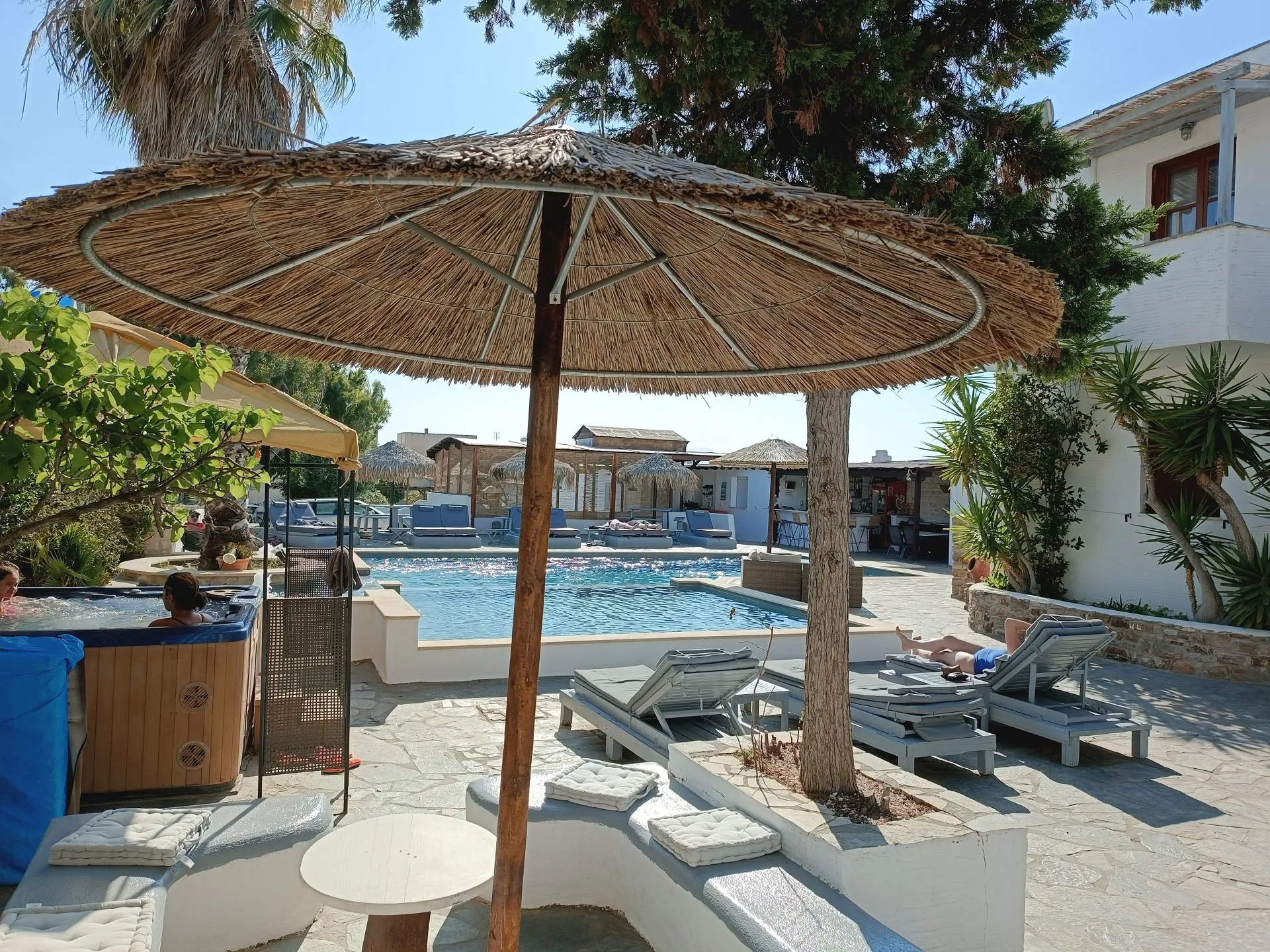 swimming pool with comfort chairs and umbrellas
