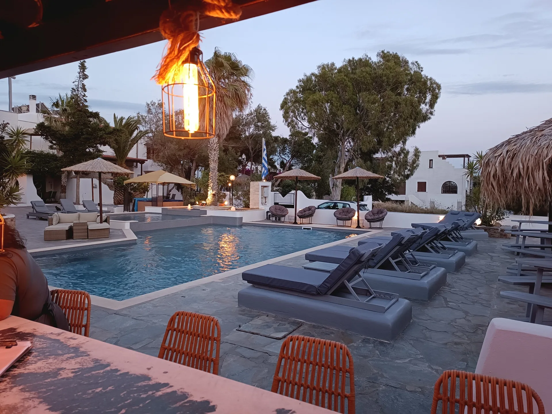 swimming pool with comfort chairs and umbrellas
