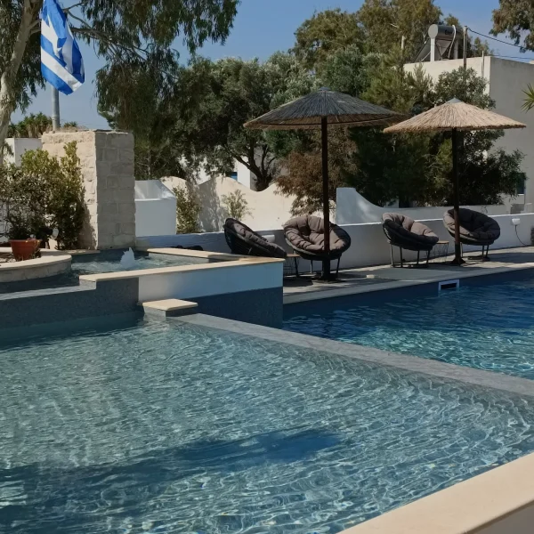swimming pool with comfort chairs and umbrellas